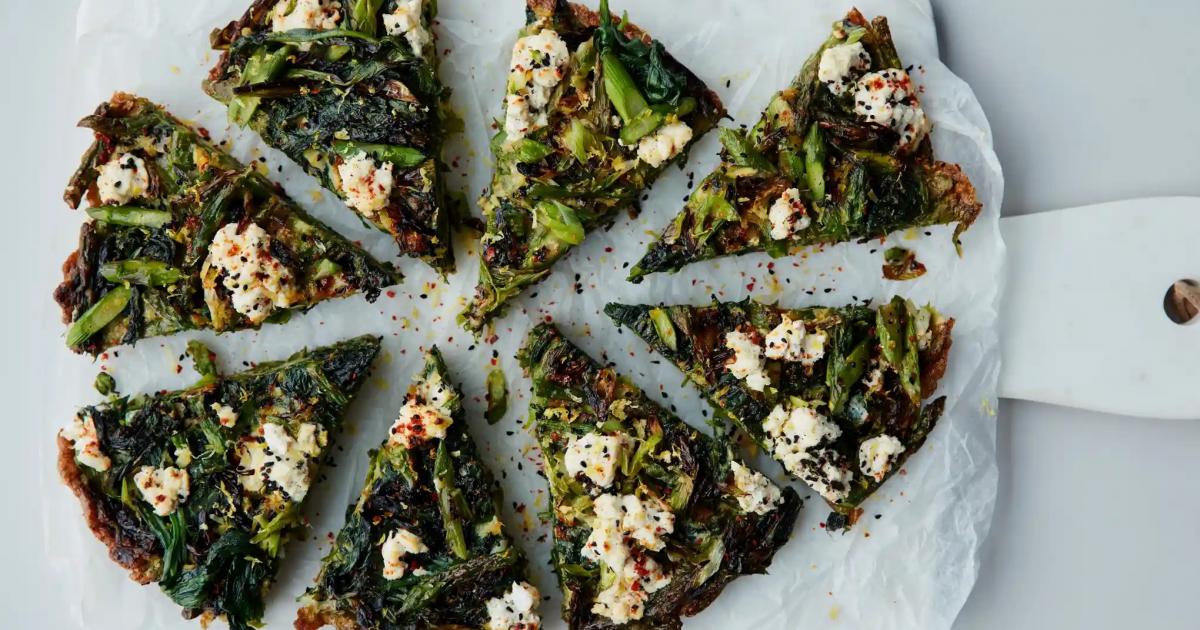 spring green frittata with wild garlic, chopped up into slices on white board,  by Anna Jones from the guardian