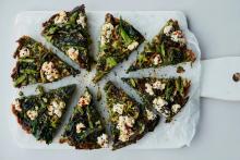 spring green frittata with wild garlic, chopped up into slices on white board,  by Anna Jones from the guardian